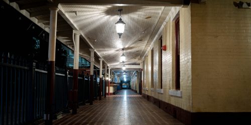 A night time photograph looking down a tiled station platform, the creepy lights make star patterns on the ceiling, they don't illuminate the ghosts that haunt Orlando Old station